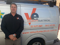 Velocity Electrical team member beside a company van